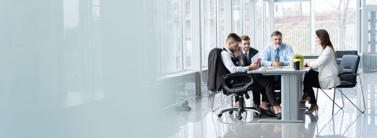 Meetingroom with four persons in it.