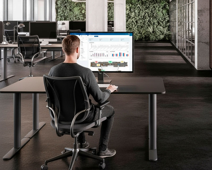 Man in office at desk looking af MyDesk Analytics
