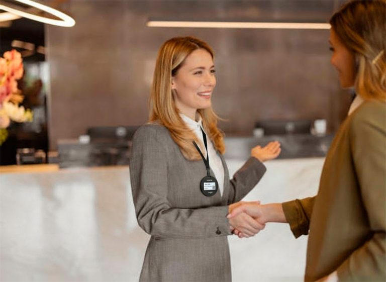 A visitor at an office, wearing an e-ink visitor card